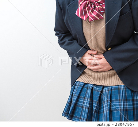 高校生 腹痛 女子生徒 手の写真素材