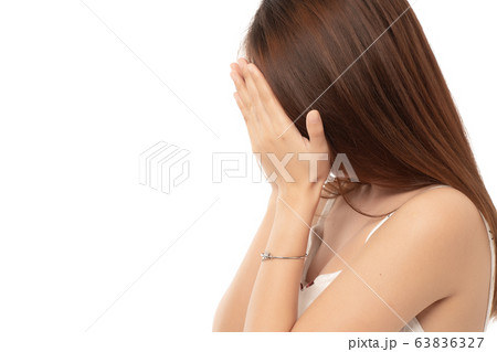 Young asian woman hides her face; failed girl doing facepalm; asian adult business woman.