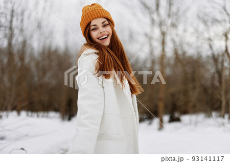 Woman in winter clothes in a hat fun winter landscape there is a