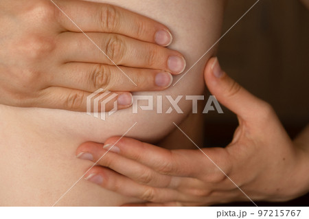 Breast screening concept. Black woman in bra rubbing her breast